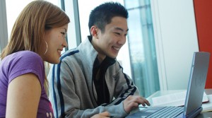 Students working at a laptop